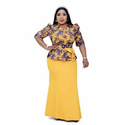 Woman wearing a yellow and purple outfit with a matching skirt, posing in front of a studio with white backdrop.