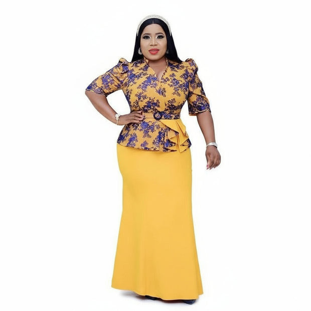 Woman wearing a yellow and purple outfit with a matching skirt, posing in front of a studio with white backdrop.