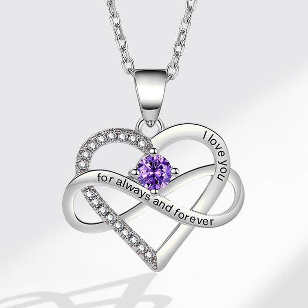 Silver heart-shaped necklace with a purple gemstone on a white background