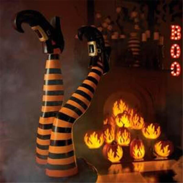 Halloween-themed decorations with striped legs and pumpkins in the background.