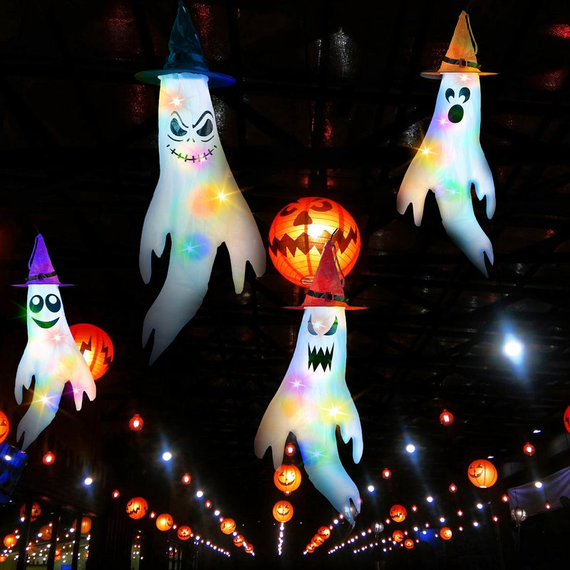 Halloween-themed decorations including ghost figures and a jack-o'-lantern with lights on a dark background.