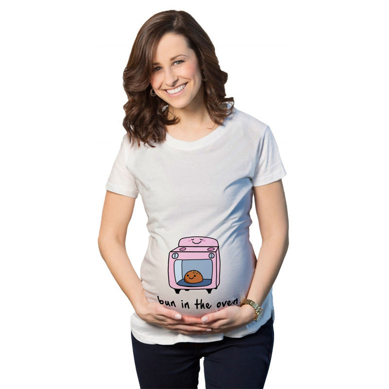 Pregnant woman wearing a white t-shirt with a graphic of a pink oven and text ' bun in the oven' on a white background