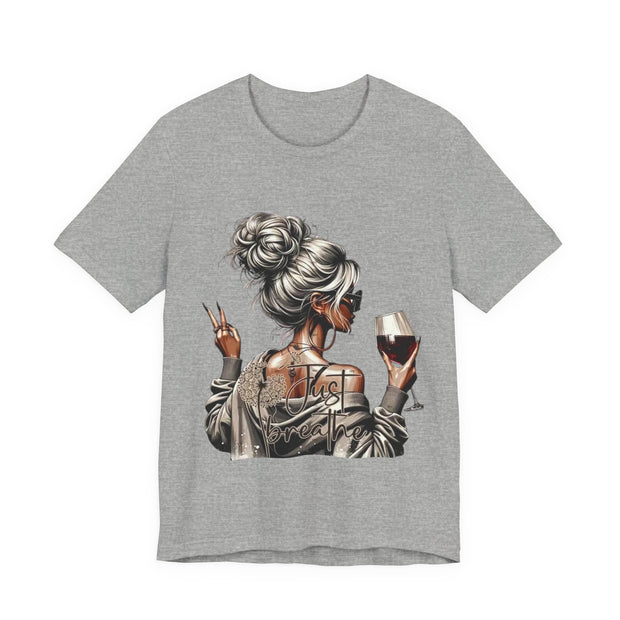 Gray t-shirt with a graphic of a woman holding a glass of wine and making a peace sign on a white background.