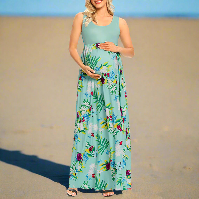 Woman wearing a floral maternity dress on a white background