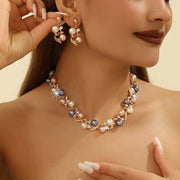 Woman wearing a pearl necklace and earrings against a beige background