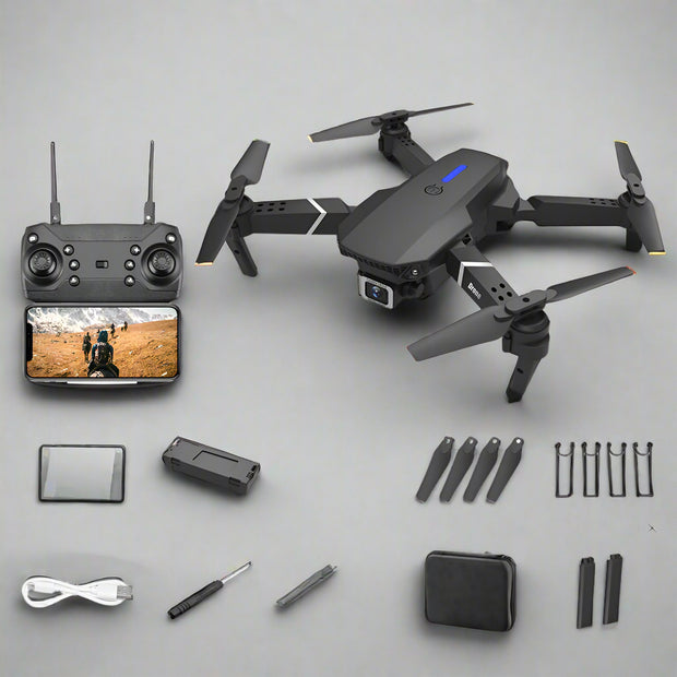 Black drone with remote control, battery, and accessories on a white background