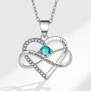Heart-shaped pendant necklace with blue gemstone and 'I love you' engraving on a light gray background