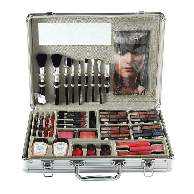 Makeup set with brushes, palettes, and other tools in an open case on a white background