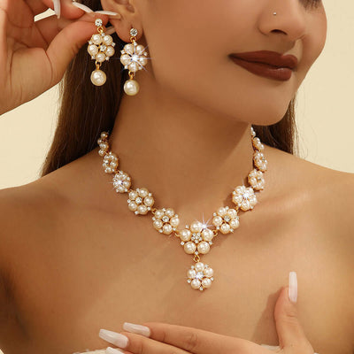 Pearl necklace and earrings on a model against a neutral background