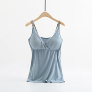 Light blue camisole on a wooden hanger against a white background