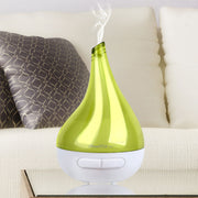 Green and white humidifier on a couch with steam rising