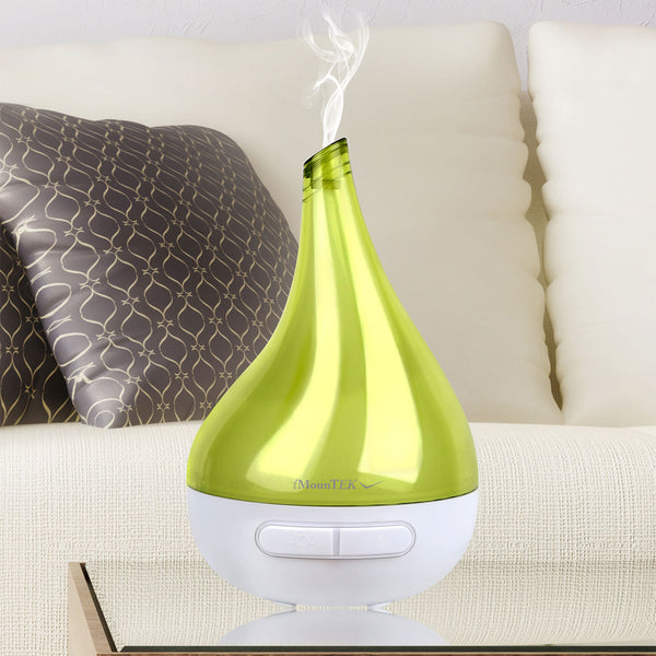 Green and white humidifier on a couch with steam rising