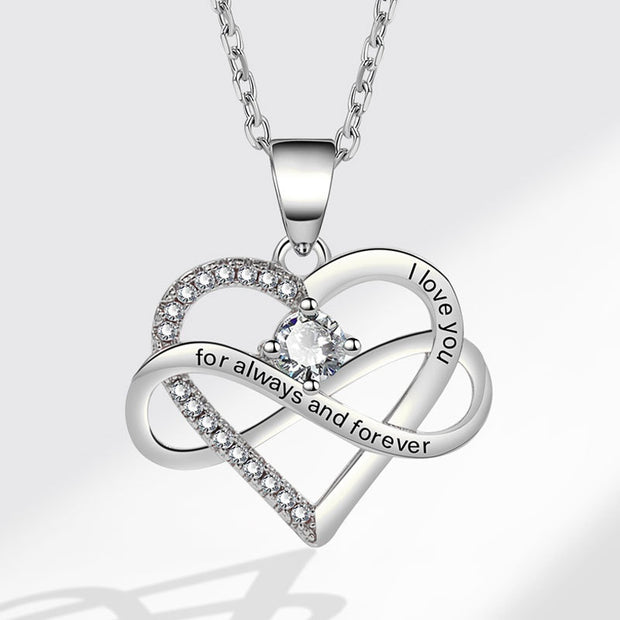 Silver heart-shaped necklace with 'I love you' and 'for always and forever' engraving on a white background