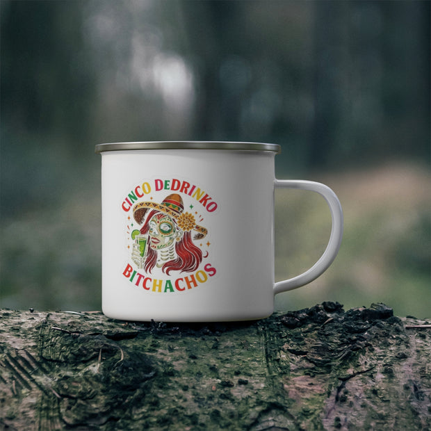 White mug with colorful design on a tree stump against a blurred natural background