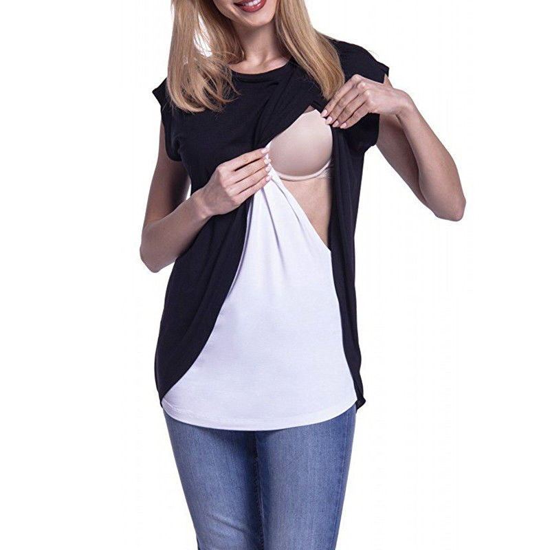 Woman wearing a black and white layered top with a beige bra and blue jeans on a white background