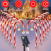 Decorative candy cane lights with solar panel in front of a house during Christmas.