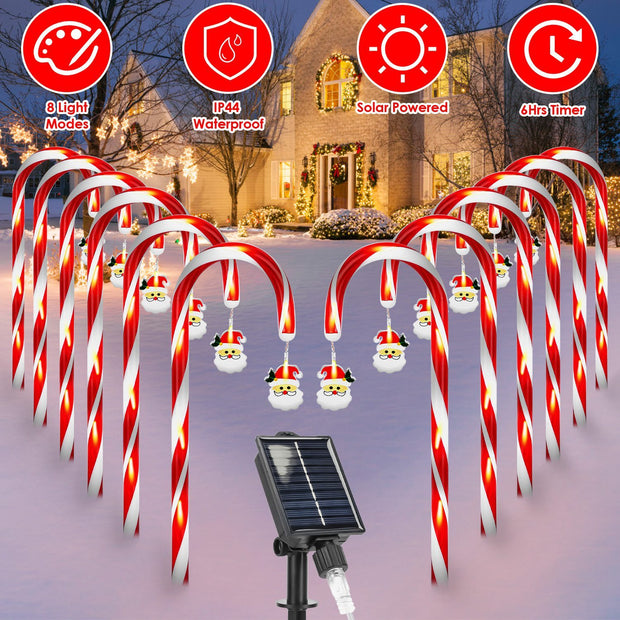 Decorative candy cane lights with solar panel in front of a house during Christmas.