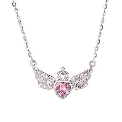 Necklace with angel wing design and pink heart-shaped gem on a white background