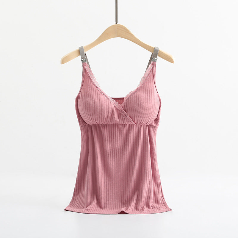 Pink ribbed camisole on a hanger against a white background