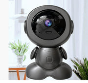 Black robot-like camera on a stand with a blurred indoor background