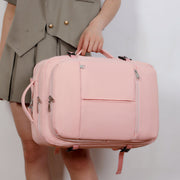 Person holding a pink suitcase against a plain background