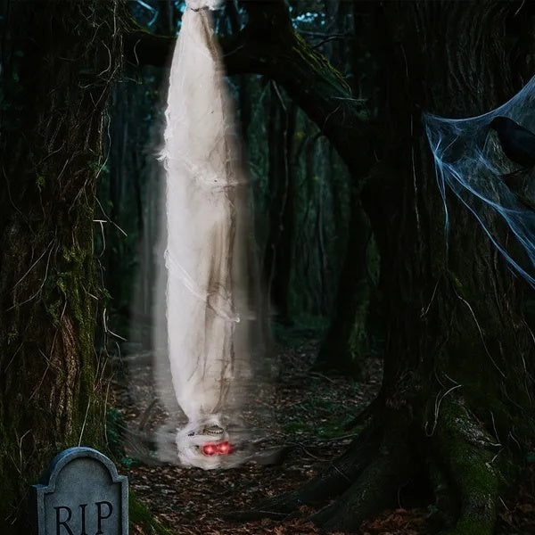 Ghostly figure wrapped in white sheet in a dark forest with tombstone