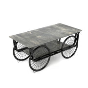 Coffee table with a stone-like top and metal wheels on a white background
