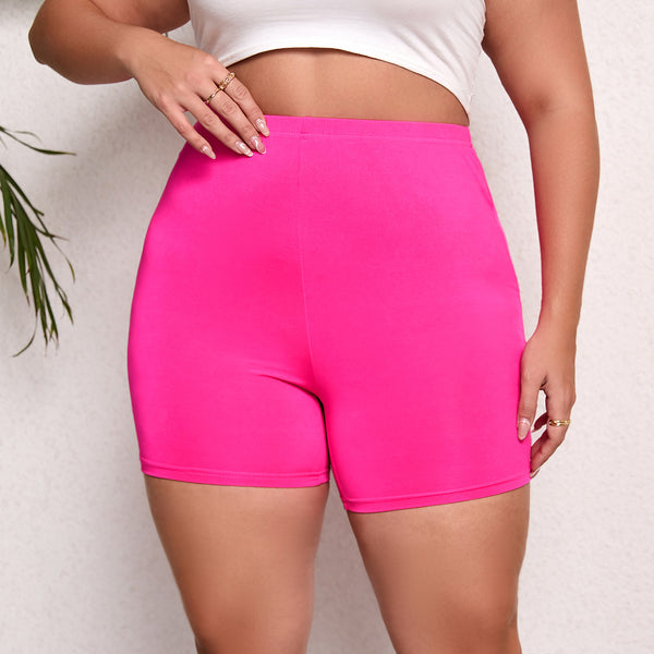 Person wearing bright pink shorts on a plain background