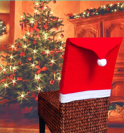 Red Santa hat on a woven basket in front of a decorated Christmas tree.