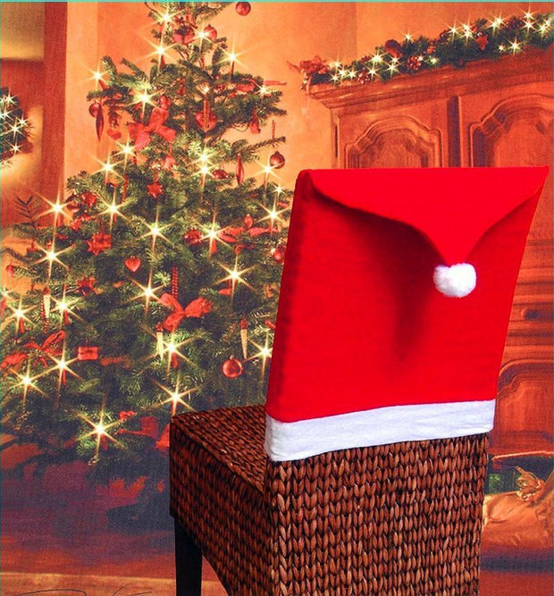 Red Santa hat on a woven basket in front of a decorated Christmas tree.
