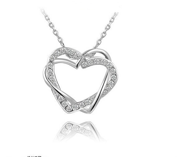Silver heart-shaped necklace with small diamonds on a white background