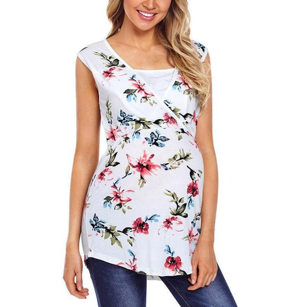 Woman wearing a white sleeveless top with colorful floral pattern on a white background