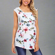 Woman wearing a white sleeveless top with colorful floral pattern on a white background