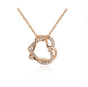 Rose gold heart-shaped necklace on a white background
