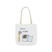 White tote bag with cartoon designs of a toothbrush, toilet paper, and text on a white background