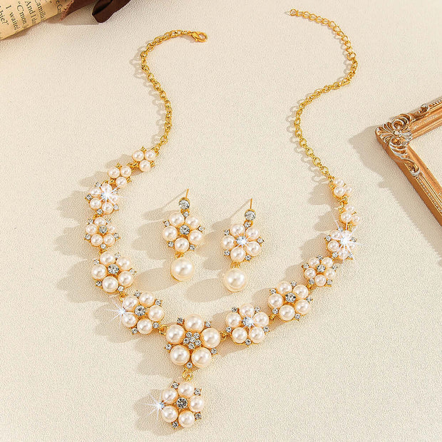 Pearl necklace and earrings set on a beige surface