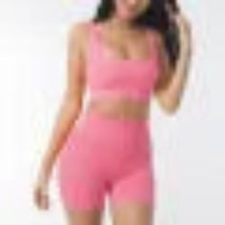 Woman wearing a pink sleeveless top and shorts set against a white background