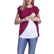 Woman wearing a two-tone top with maroon and white sections on a white background