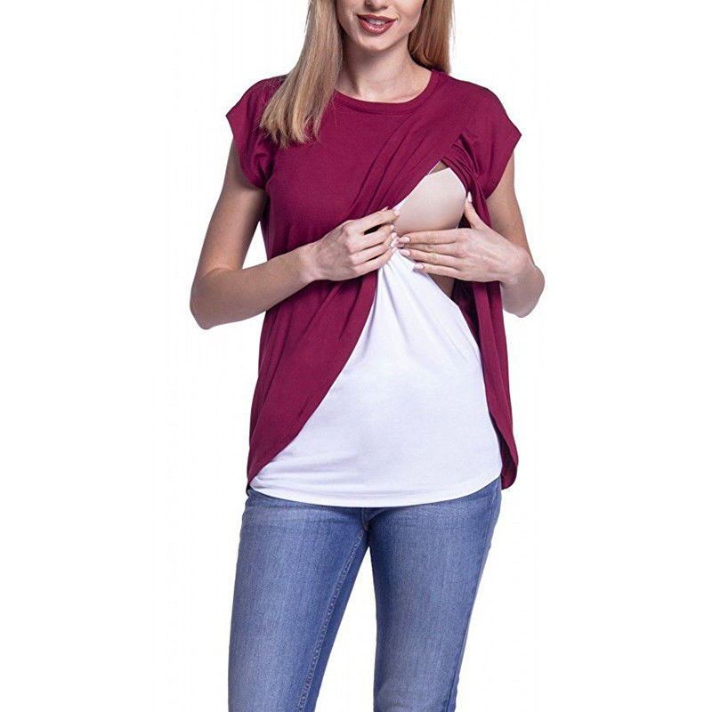 Woman wearing a two-tone top with maroon and white sections on a white background