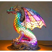Colorful dragon-shaped lamp with stained glass design on a plain background