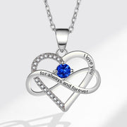 Heart-shaped silver necklace with blue gemstone and 'I love you' engraving on a white background