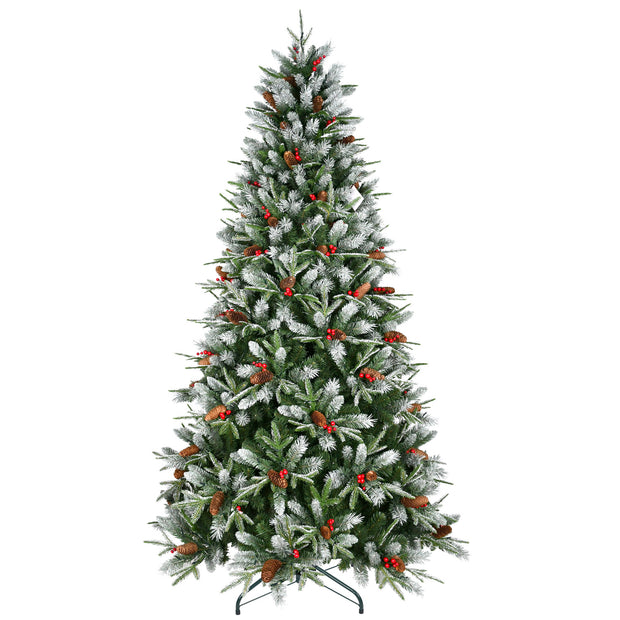Decorated Christmas tree with snow, red berries, and pinecones on a white background