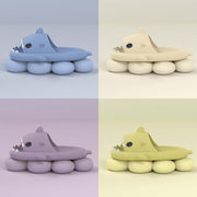 Colorful cartoon shark slippers in blue, yellow, purple, and green, designed for fun indoor and outdoor use.