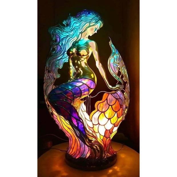 Colorful mermaid lamp with stained glass design on a dark background