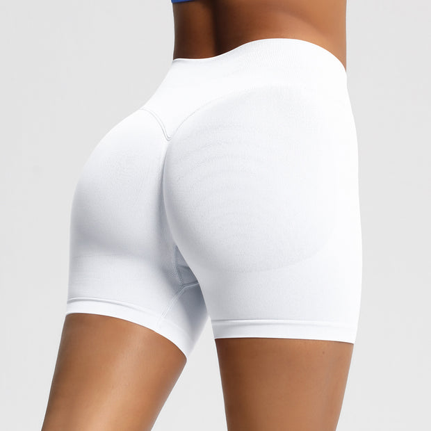 White athletic shorts worn by a person on a plain background