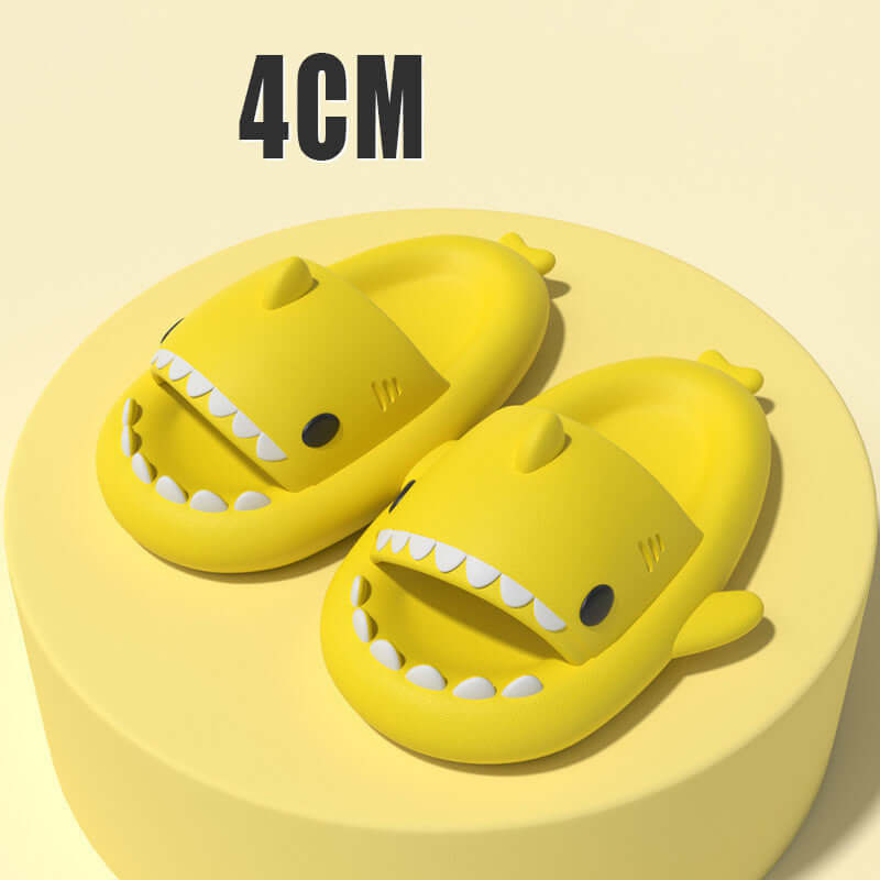 Fun yellow cartoon shark slippers on a yellow platform, designed for comfort and playful style.