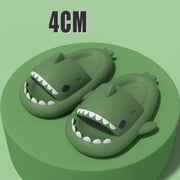 Green cartoon shark slippers with open mouths, designed for fun and comfort, featuring a soft, elastic build for adults.