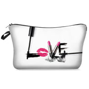 Clear makeup bag with black brush strokes, pink lipstick, and red lip print on a white background