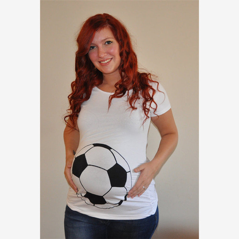 Woman wearing a white t-shirt with a soccer ball design, standing against a plain background.