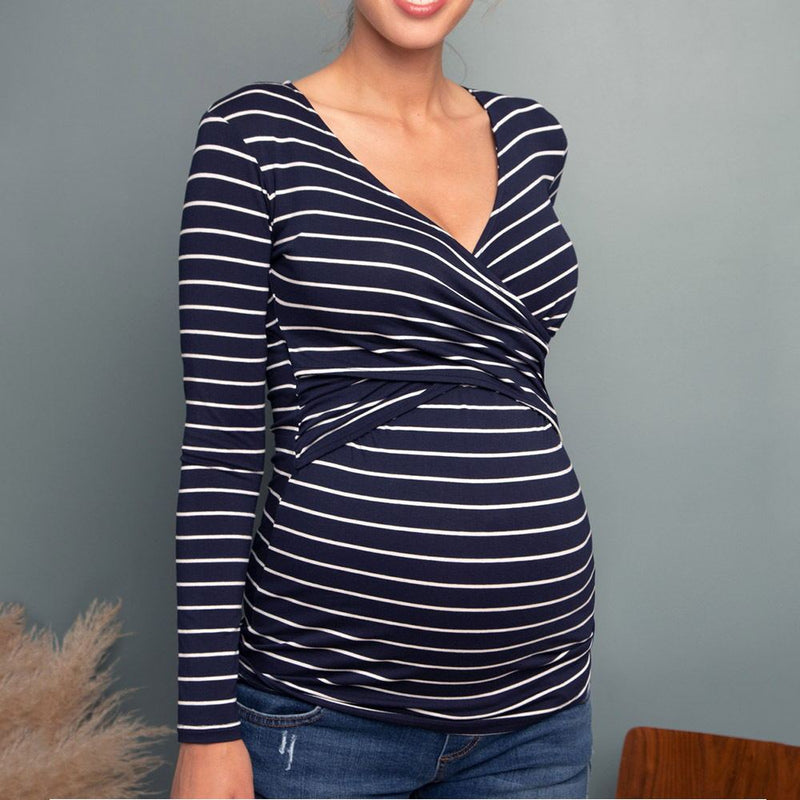 Navy and white striped long-sleeve top worn by a person against a gray background